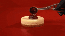 The cherry cheesecake being placed together