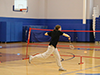 girl playing bad mitton inside a gym