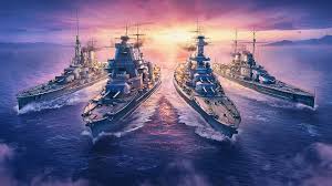 4 battleships sailing forward with a sunset behind them