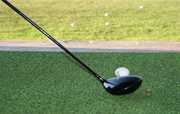 driver and golf ball on the tee box