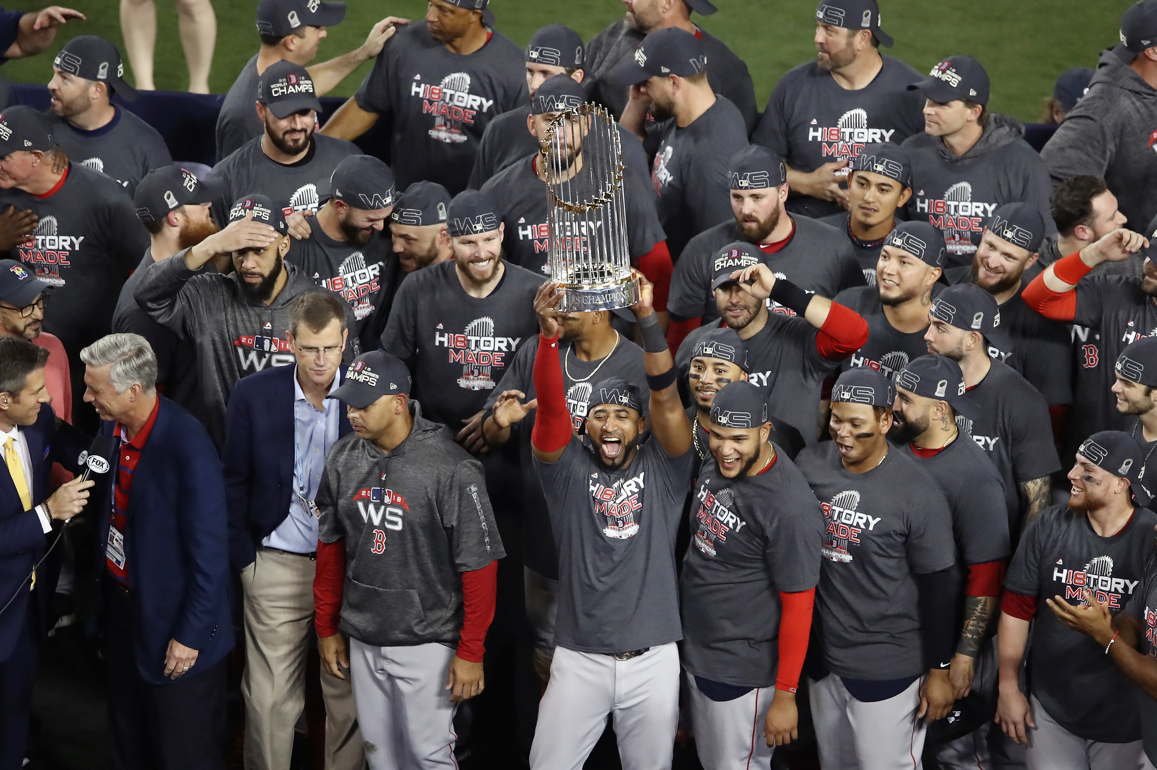 The Red Soxs winning the world series holding the trophy.