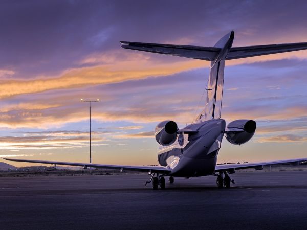 Private jet in front of a sunset