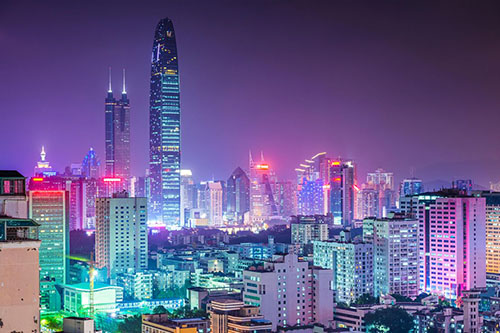 The city of Shenzhen at night with a bright display of lights.